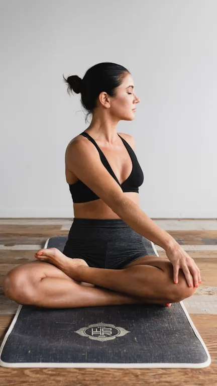 Persona en una sesión de pilates, sentada con calma sobre la colchoneta